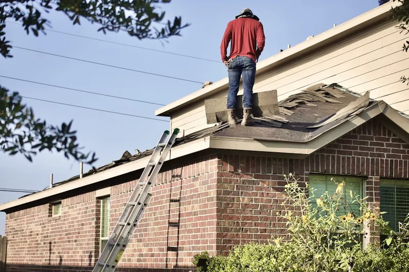 Professional roofer working on a residential roof in Sherwood West